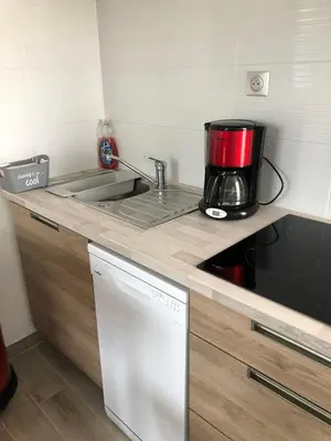 a kitchen with a sink and a coffee pot on a counter at Charming 38m2 city house in Le Cannet