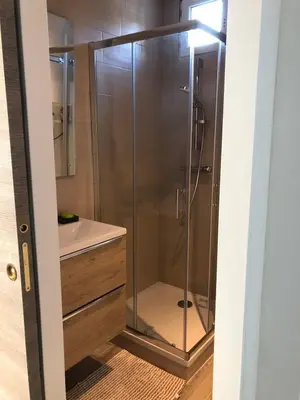 a shower with a glass door in a bathroom at Charming 38m2 city house in Le Cannet
