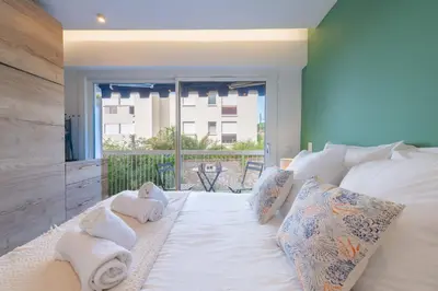a bedroom with a bed with towels on it at 1-Br Apartment Quiet Setting Near City Center in Cannes