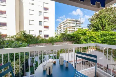 a blue table and chairs on a balcony at 1-Br Apartment Quiet Setting Near City Center in Cannes