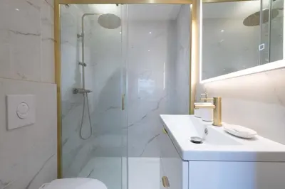 a bathroom with a shower and a toilet and a sink at 1-Br Apartment Quiet Setting Near City Center in Cannes