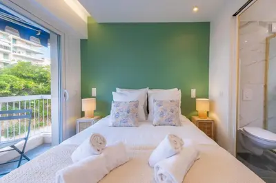 a bedroom with a large bed with towels on it at 1-Br Apartment Quiet Setting Near City Center in Cannes