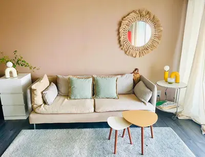 a living room with a couch and a mirror at Grande studio, Vue mer magnifique in Cannes