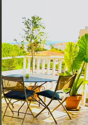 a table and two chairs sitting on a balcony at Grande studio, Vue mer magnifique in Cannes