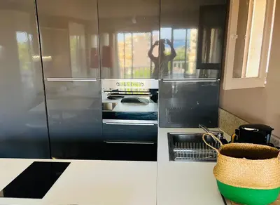 a kitchen with a stainless steel refrigerator and a stove at Grande studio, Vue mer magnifique in Cannes