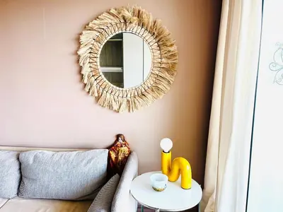 a living room with a mirror and a couch at Grande studio, Vue mer magnifique in Cannes