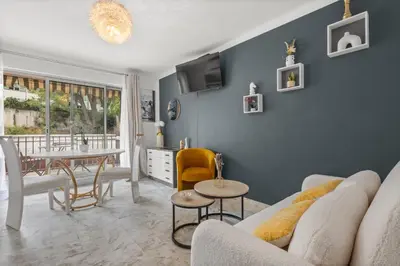 a living room with a couch and a table at Studio in Cannes city center with terrace in Cannes