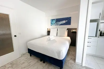 a bedroom with a bed and a mirror at Studio in Cannes city center with terrace in Cannes