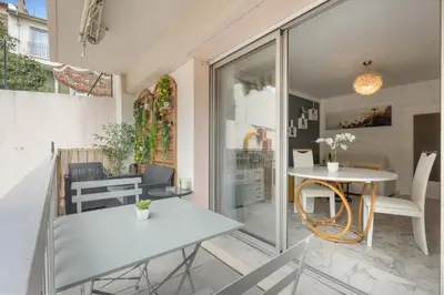 a patio with a table and a table and chairs at Studio in Cannes city center with terrace in Cannes
