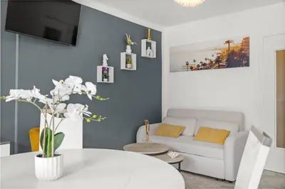 a living room with a white couch and a table at Studio in Cannes city center with terrace in Cannes
