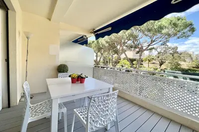 a white table and chairs on a balcony at Beautiful T2 large terrace near Center & sea in Cannes