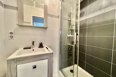 a bathroom with a sink and a shower at Beautiful T2 large terrace near Center & sea in Cannes