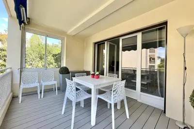 a white table and chairs on a balcony at Beautiful T2 large terrace near Center & sea in Cannes