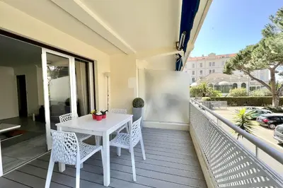 a white table and chairs on a balcony at Beautiful T2 large terrace near Center & sea in Cannes