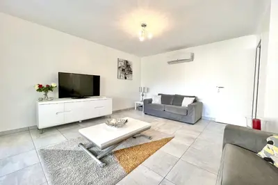 a living room with a television and a couch at Beautiful T2 large terrace near Center & sea in Cannes