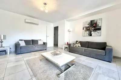 a living room with two couches and a table at Beautiful T2 large terrace near Center & sea in Cannes
