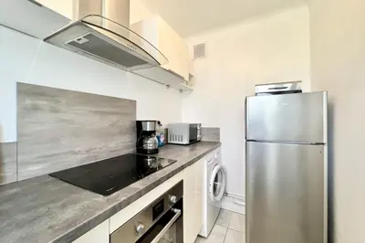a kitchen with a stainless steel refrigerator at Beautiful T2 large terrace near Center & sea in Cannes