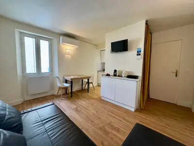 a living room with a couch and a table at Le Laguna - SCLS Locations in Cannes