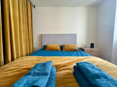 a bedroom with a bed with blue pillows on it at Le Laguna - SCLS Locations in Cannes