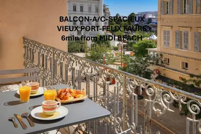 a table with two plates of food on a balcony at Spacieux 2 chambres BALCON, FELIX FAURE-COEUR DE CANNES A2B023 in Cannes