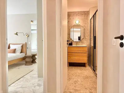 a bathroom with a vanity and a bedroom with a bed at Cannes 2 bedrooms Apartment - MAD 20 in Cannes
