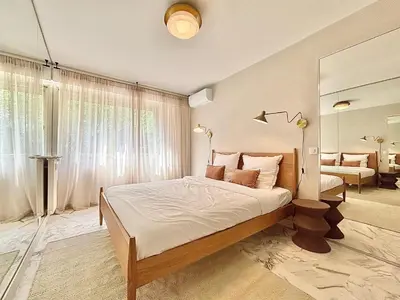 a bedroom with a large bed and a mirror at Cannes 2 bedrooms Apartment - MAD 20 in Cannes