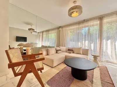 a living room with a couch and a table at Cannes 2 bedrooms Apartment - MAD 20 in Cannes