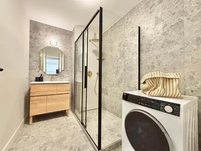 a washing machine in a bathroom with a shower at Cannes 2 bedrooms Apartment - MAD 20 in Cannes