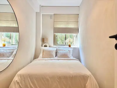 a bedroom with a bed with a round mirror at Cannes 2 bedrooms Apartment - MAD 20 in Cannes