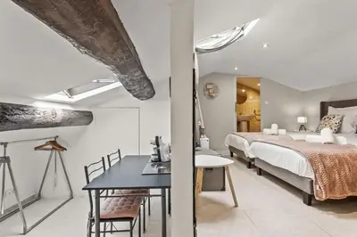 a bedroom with a bed and a table and a desk at Studio Cannes city center in Cannes