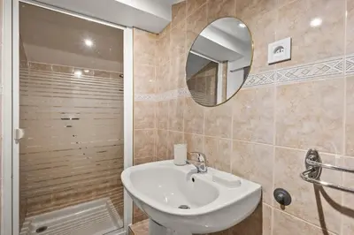 a bathroom with a sink and a mirror at Studio Cannes city center in Cannes