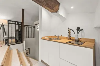 a kitchen with white walls and a counter with a sink at Studio Cannes city center in Cannes