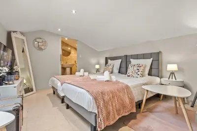 a bedroom with a large bed and two tables at Studio Cannes city center in Cannes