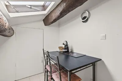 a room with a black table with a laptop on it at Studio Cannes city center in Cannes