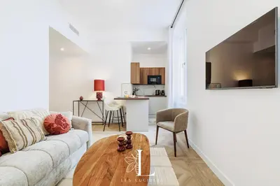 a living room with a couch and a table at Les Lucioles 1 - Luxury 1 Bedroom Apartment in Cannes