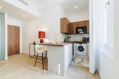 a kitchen with a counter and a washing machine at Les Lucioles 1 - Luxury 1 Bedroom Apartment in Cannes
