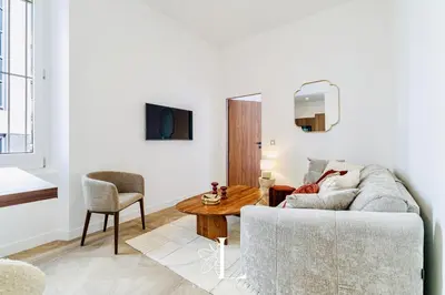 a living room with a couch and a table at Les Lucioles 1 - Luxury 1 Bedroom Apartment in Cannes