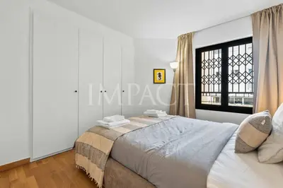 a bedroom with a bed and a window at REF 2014 - Cannes center - Apartment to rent in Cannes