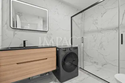 a washing machine in a bathroom with a mirror at REF 2014 - Cannes center - Apartment to rent in Cannes