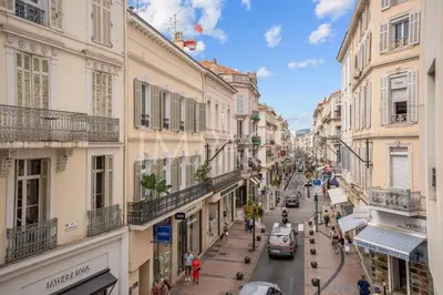 a city street with buildings and people walking on the street at REF 2014 - Cannes center - Apartment to rent in Cannes