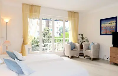 a bedroom with two beds and a window at Spacious Studio Apartment Near The Beach - 2313 in Cannes