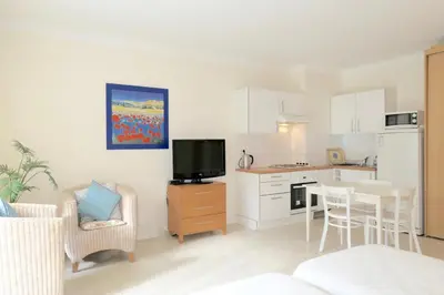 a living room with a kitchen and a dining room at Spacious Studio Apartment Near The Beach - 2313 in Cannes