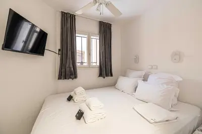a bedroom with a bed with towels on it at Charming flat with sea view - 1BR - 2P - Cannes in Cannes