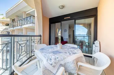 a table and chairs on the balcony of a apartment at Charming flat with sea view - 1BR - 2P - Cannes in Cannes
