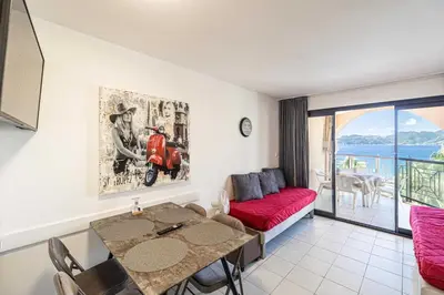 a living room with a table and a couch at Charming flat with sea view - 1BR - 2P - Cannes in Cannes