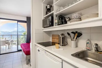 a kitchen with a sink and a balcony at Charming flat with sea view - 1BR - 2P - Cannes in Cannes