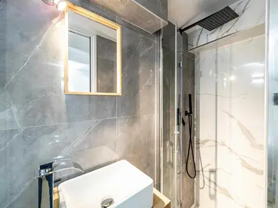 a bathroom with a white sink and a shower at Modern a c apartment 2BR 8P - Cannes in Cannes