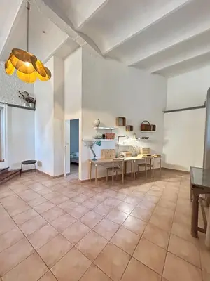 a large living room with a table and chairs at Large duplex with garden in historic house in Le Cannet