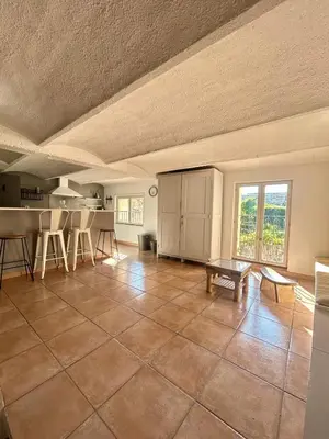 a large kitchen with a tile floor and a table at Large duplex with garden in historic house in Le Cannet