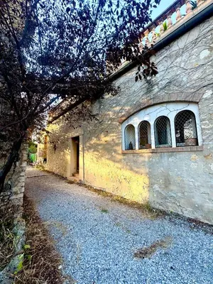 a stone building with a window on the side of it at Large duplex with garden in historic house in Le Cannet